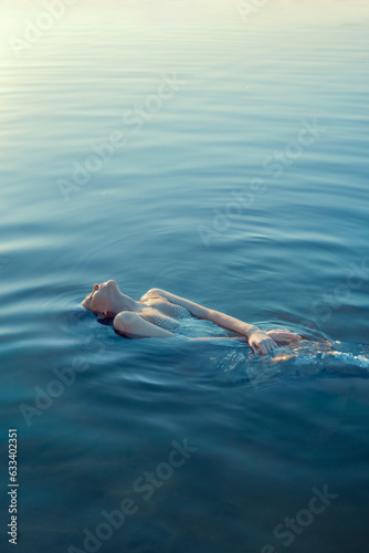 Beautiful redhead woman as mermaid with giant seashell