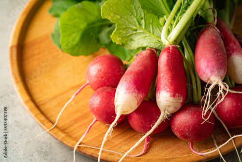 Fresh radish lies on gray background Diet food. Fresh vegetables for making vitamin salad.