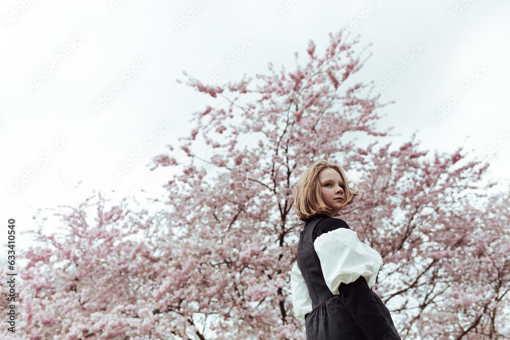 Girl standing near blooming tree Girl standing near blooming tree