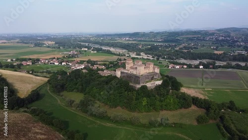 Aerial drone view of castle called Castello di Torrechiara, Parma, Emilia-Romagna, Italy. Bird eye view of Italian castle with towers and Medieval and Renaissance architecture features on green hill