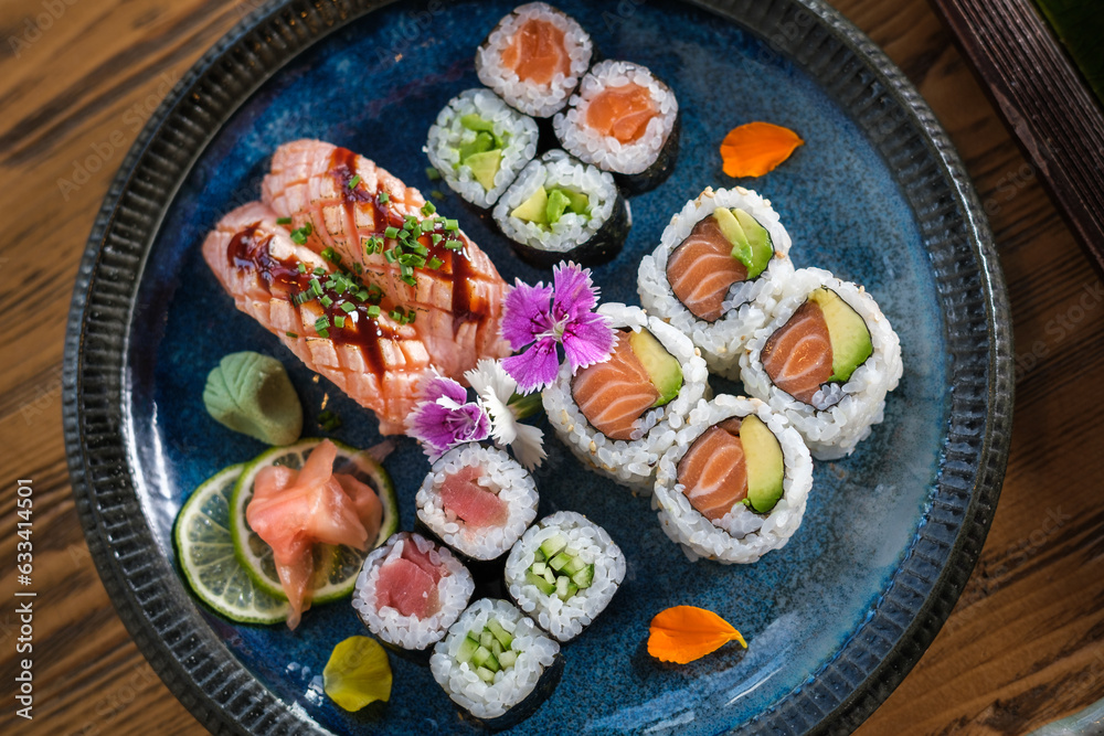 Plate with assorted sushi served with wasabi and ginger Plate with assorted sushi served with wasabi and ginger