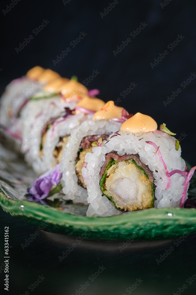 Delicious sushi rolls with sauce on marble tray Delicious sushi rolls with sauce on marble tray