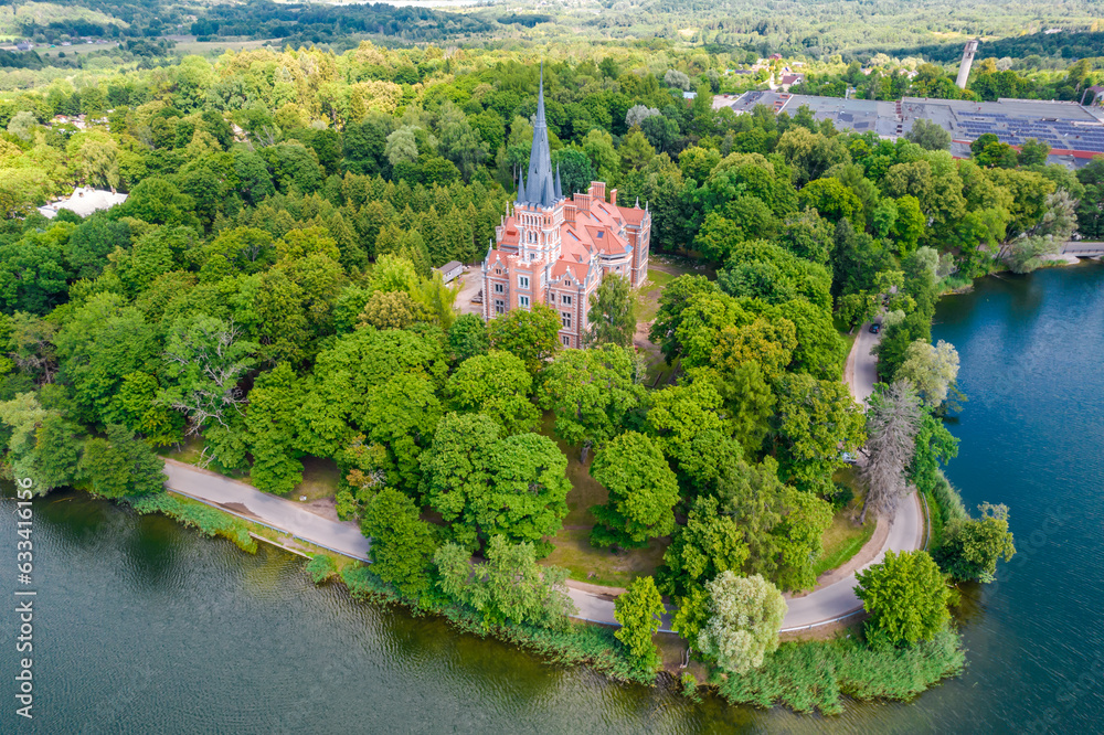Palace Tyszkiewicz (Tiskeviciai manor) in Lentvaris on the coast of the lake, Lithuania. Aerial view of Tudor style castle