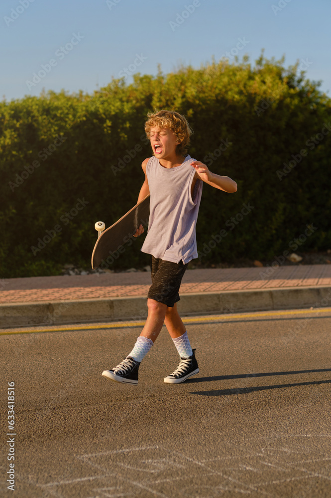 Expressive skater walking with skateboard along road