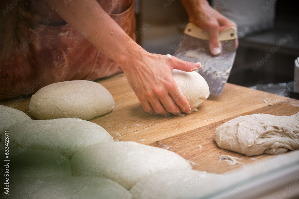 Photo detail of a baker's hands working the bread dough