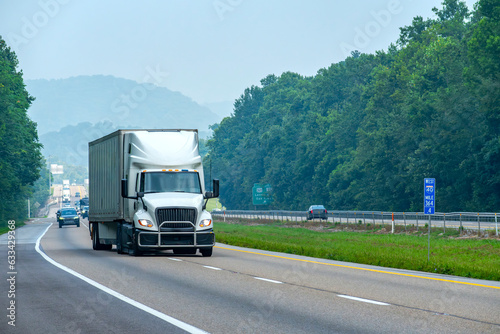 Large White Truck Changes Lanes On Interstate Highway