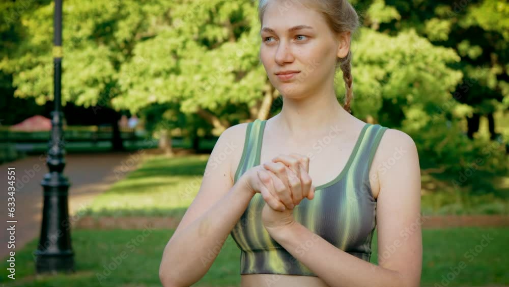 Portrait woman in sportswear warm up her body before doing workout burning fat calories training strength practicing effort fitness aerobics. Sportswear female exercises outdoors for health and Portrait woman in sportswear warm up her body before doing workout burning fat calories training strength practicing effort fitness aerobics. Sportswear female exercises outdoors for health and