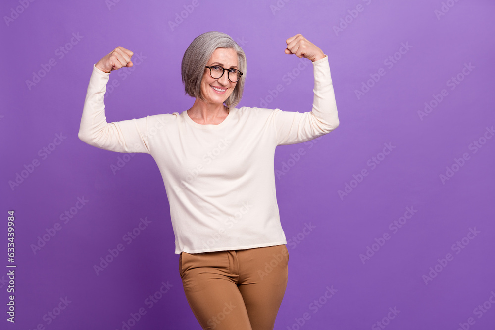 Photo of charming business lady show double biceps muscles arms fists up big experience market leader isolated over purple color background Photo of charming business lady show double biceps muscles arms fists up big experience market leader isolated over purple color background