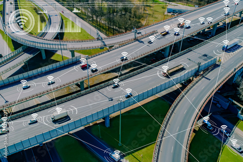 Road junction with cars. Satellite navigation for transport. Road trestle view from quadrocopter. Navigation technologies. Cars are connected by lines. Satellite navigation for traffic management