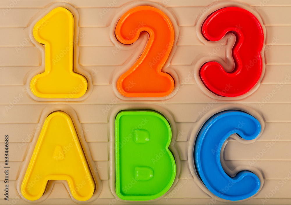 Close up photo of kids toy multi colored numbers and alphabet letters. Close up photo of kids toy multi colored numbers and alphabet letters.