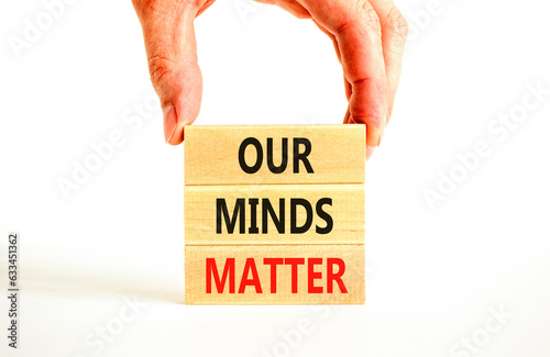 Our minds matter ourmindsmatter symbol. Concept words Our minds matter on wooden block. Beautiful white table white background. Businessman hand. Our minds matter ourmindsmatter concept. Copy space. photo