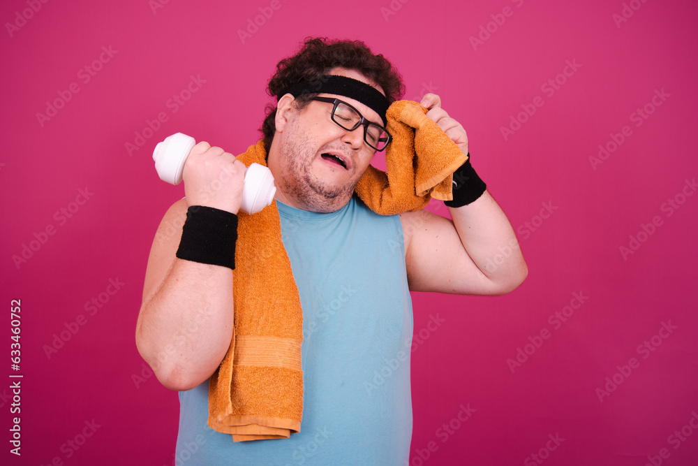 Funny fat man is engaged in fitness. Retro style. Pink background. Funny fat man is engaged in fitness. Retro style. Pink background.
