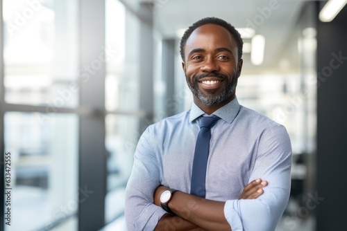 Portrait of a middle aged african american businessman looking at the camera in an office © NikoG