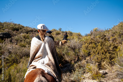 Country postcard of horseback riding outdoors. Gaucho woman riding in the open air (ID: 633473117)