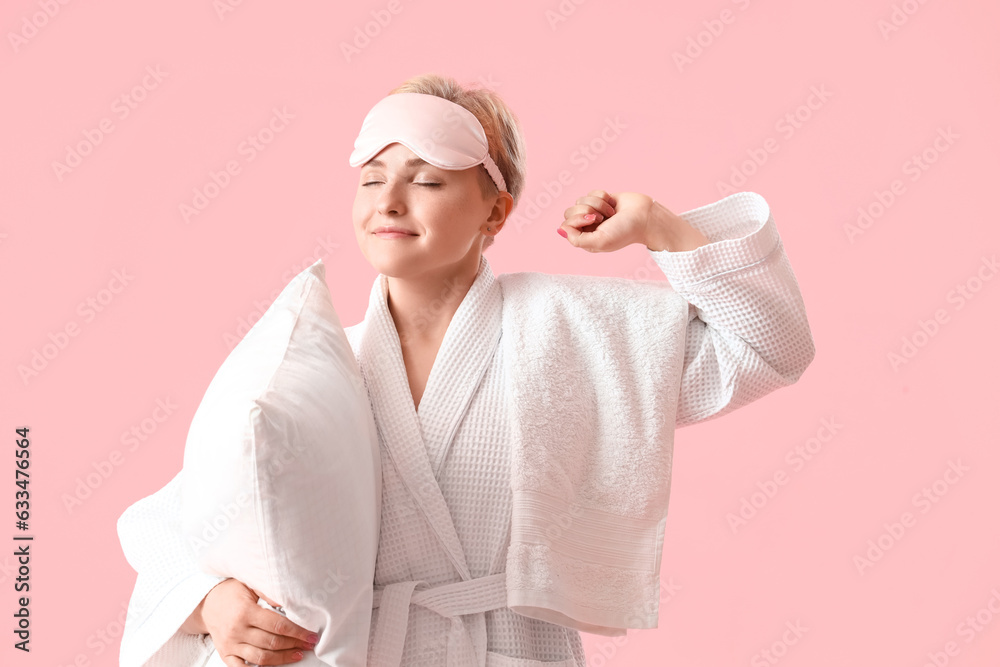 Young woman in sleeping mask with pillow on pink background Young woman in sleeping mask with pillow on pink background