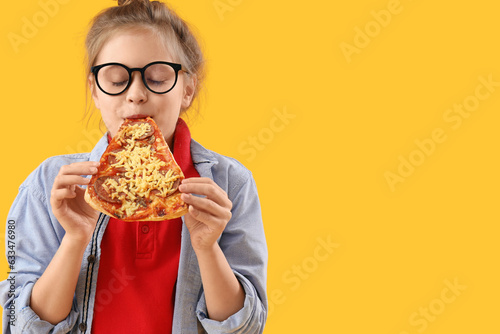 Little girl eating tasty pi...