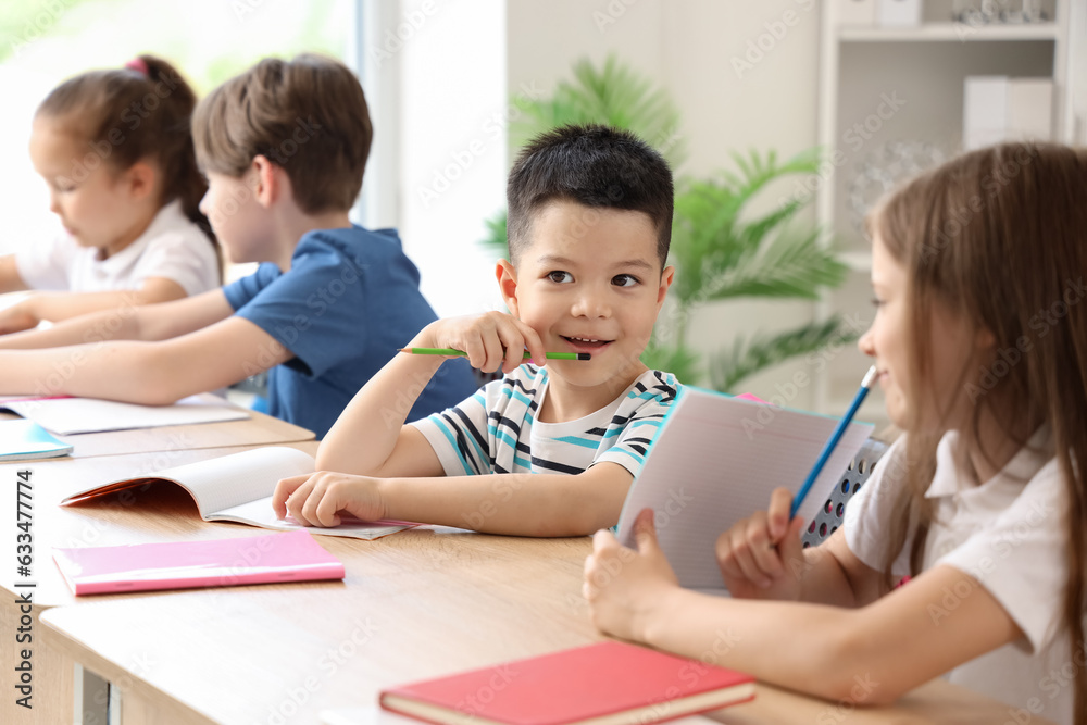Little schoolboy having lesson in classroom Little schoolboy having lesson in classroom