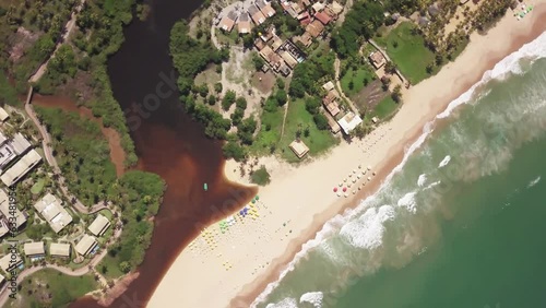 Imbassai Beach, Bahia. Aerial view. River meets sea waves
 photo