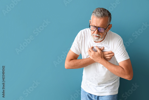 Mature man having heart att...