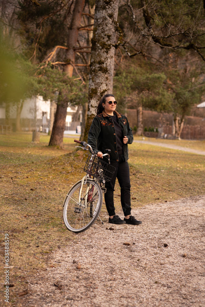 girl on a bike walking in a park