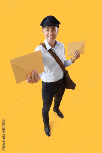 Mature postman with envelop...