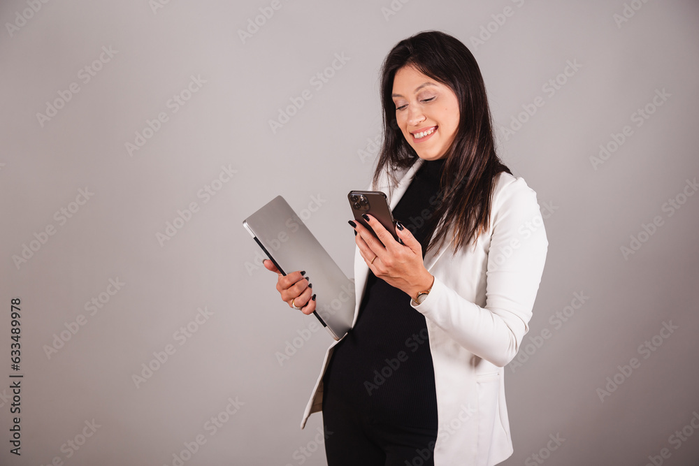 Business woman wearing white suit. Aesthetics professional. notebook and smartphone. Business woman wearing white suit. Aesthetics professional. notebook and smartphone.