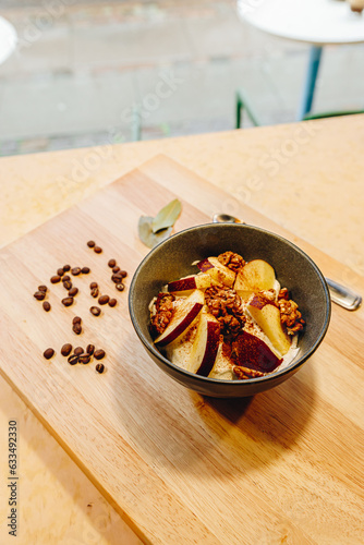 presentation of a bowl with yogurt, apples and nuts, decorated and healthy plate