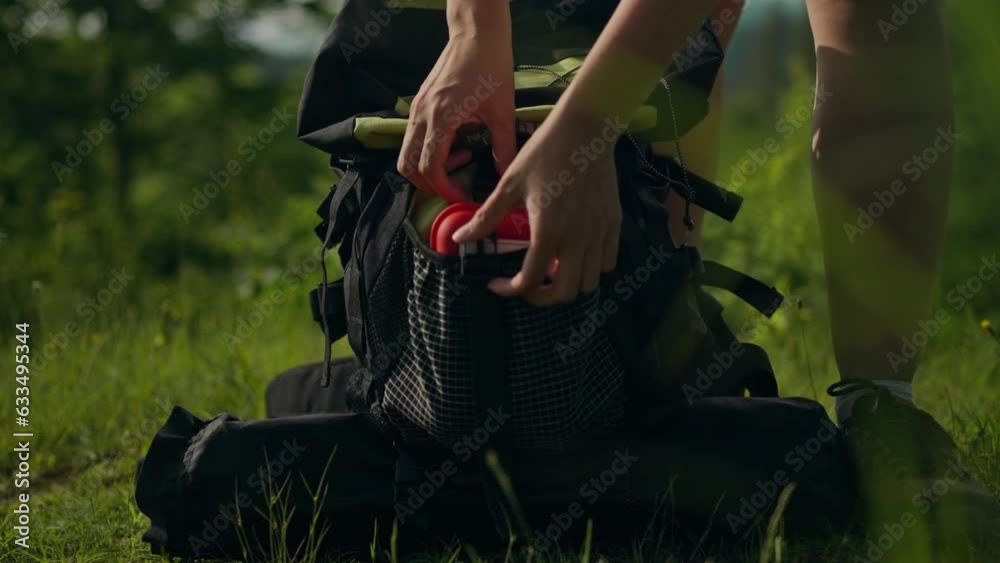 New impressions, traveler Gets first aid out of a backpack In a mountainous area. Vegan develops the feeling of a tourist explorer learns new techniques for testing himself in the wild, winner