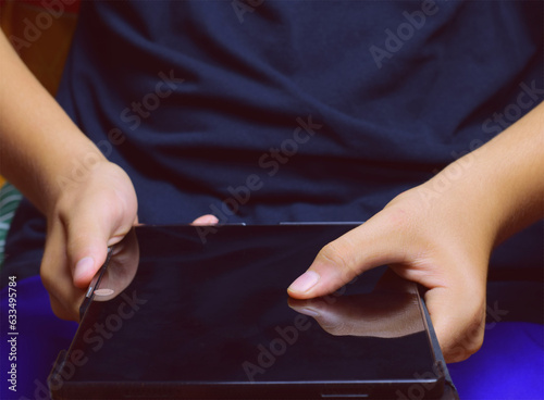 Young man, interacting with the tablet.