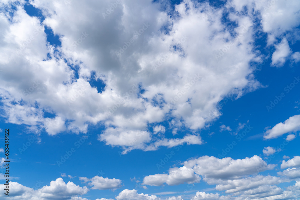 white fluffy clouds standing out against a black background and a blue sky white fluffy clouds standing out against a black background and a blue sky
