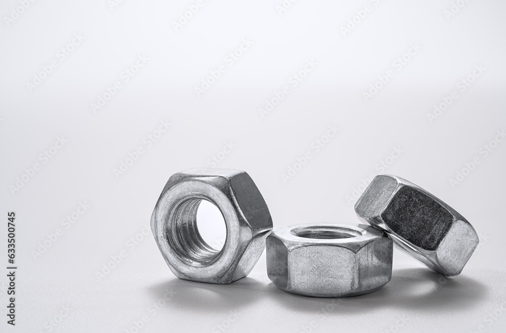 Industrial steel hardware nuts isolated on a white background Industrial steel hardware nuts isolated on a white background