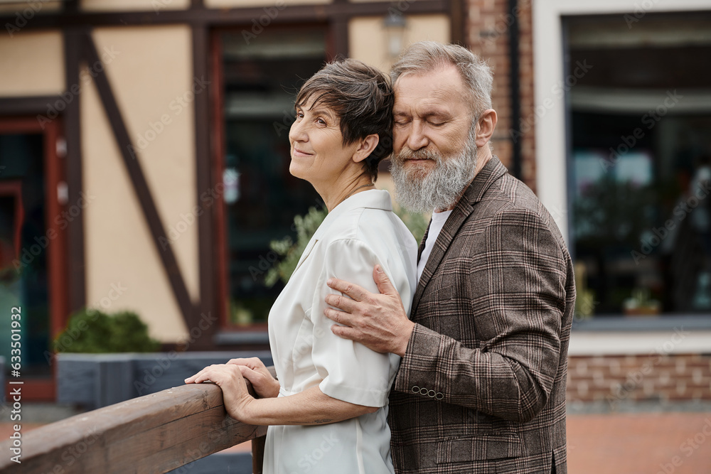 bearded man hugging woman, husband and wife, senior romance, love, aging population, outdoors