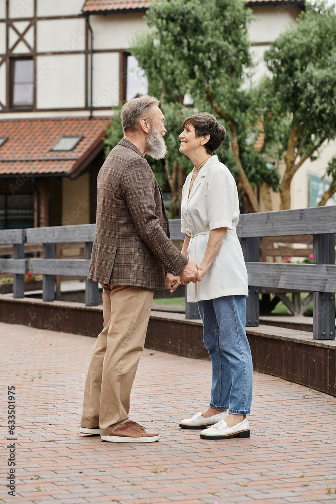 woman and bearded man holding hands, date, senior romance, happy elderly couple, full length woman and bearded man holding hands, date, senior romance, happy elderly couple, full length