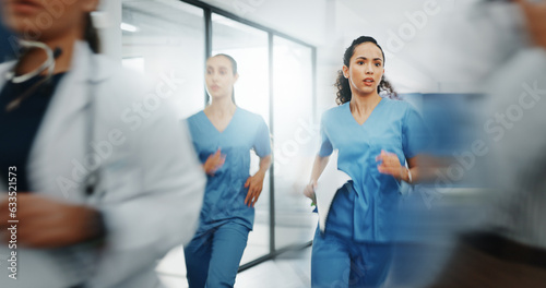 Doctors, nurses or running in hospital emergency, patient crisis or pager call in ICU stress, trauma fail or diversity clinic. Healthcare women, rushing or run in medical hallway to code blue problem photo