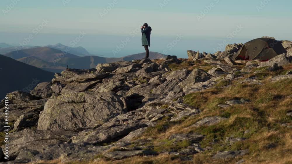 A man drinking tea on top of a mountain in Wales A man drinking tea on top of a mountain in Wales