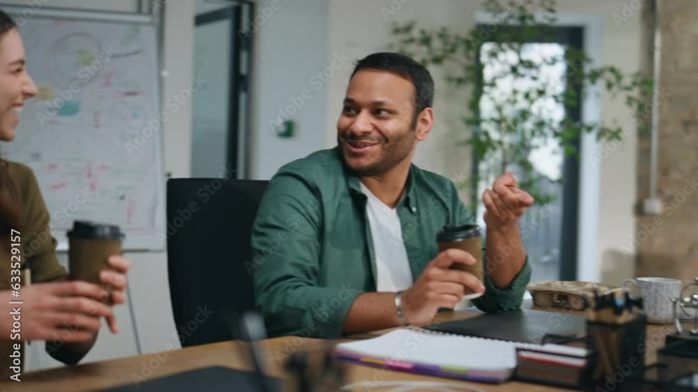 Smiling business team talking holding coffee in office closeup. Happy colleagues Smiling business team talking holding coffee in office closeup. Happy colleagues