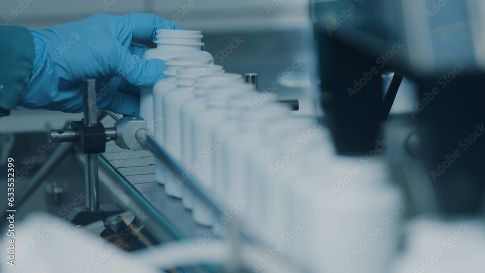 4K conveyor with moving empty white plastic tubes on the production line and filling with capsules. Automatic machine in the factory. Modern High-Tech Pharmacology Factory. Close Up, DOF 4K conveyor with moving empty white plastic tubes on the production line and filling with capsules. Automatic machine in the factory. Modern High-Tech Pharmacology Factory. Close Up, DOF