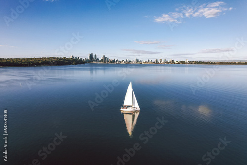 Quadro su tela A yacht sailing on the Swan River in Matilda Bay with the Perth city skyline beh