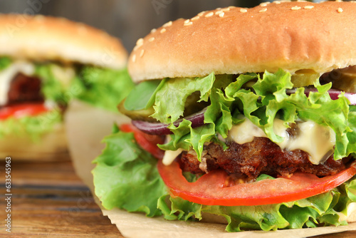 Delicious burger with beef patty and lettuce on table, closeup. Space for text