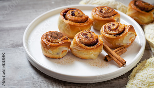 Food, pastry, baking. homemade snail buns with sugar and cinnamon on white plate