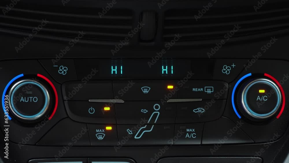 Finger presses button for turning on maximum airflow on the multimedia panel of car, two-phase climate control in the car Finger presses button for turning on maximum airflow on the multimedia panel of car, two-phase climate control in the car