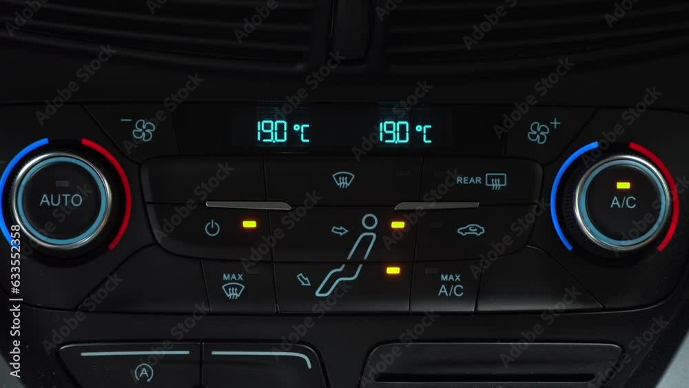 Finger turning on toggle switch of car air conditioner driver face and legs blow mode, two-phase climate control in the car Finger turning on toggle switch of car air conditioner driver face and legs blow mode, two-phase climate control in the car