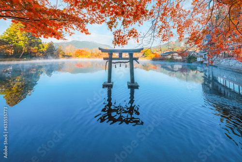 Yufuin, Japan - Nov 27 2022: Tenso-jinja shrine at lake Kinrin, is one of the representative sightseeing spots in the Yufuin area at the foot of Mount Yufu. photo