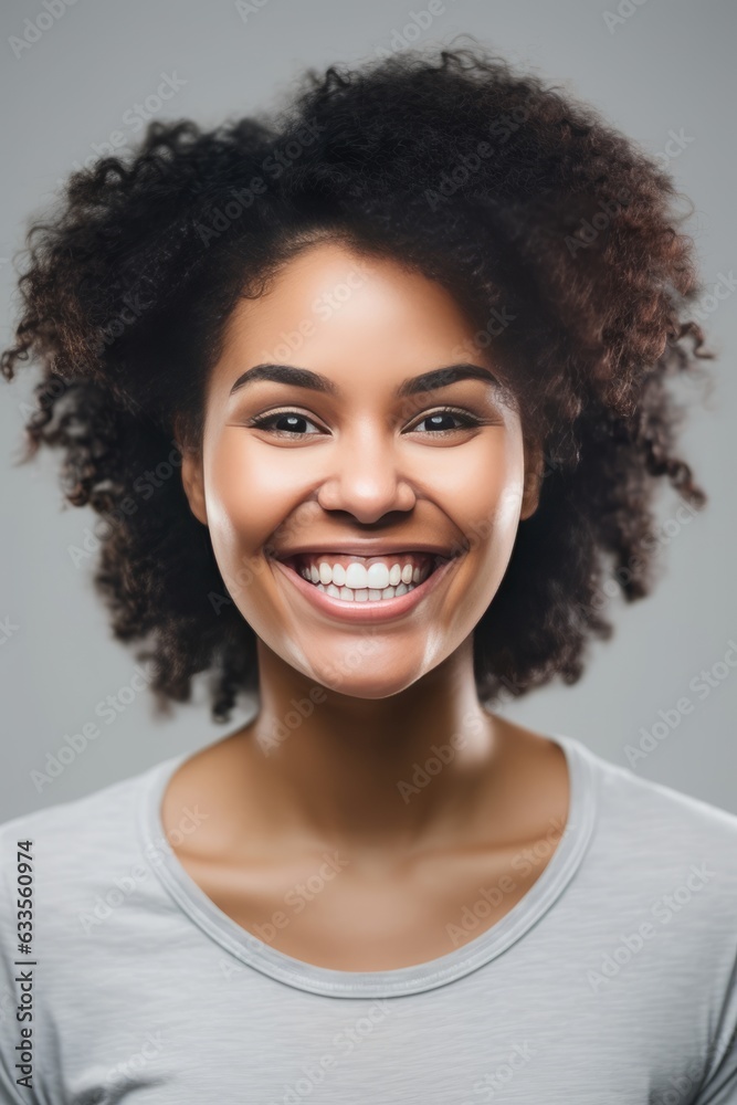 headshot of a happy young woman looking at the camera on gray background headshot of a happy young woman looking at the camera on gray background