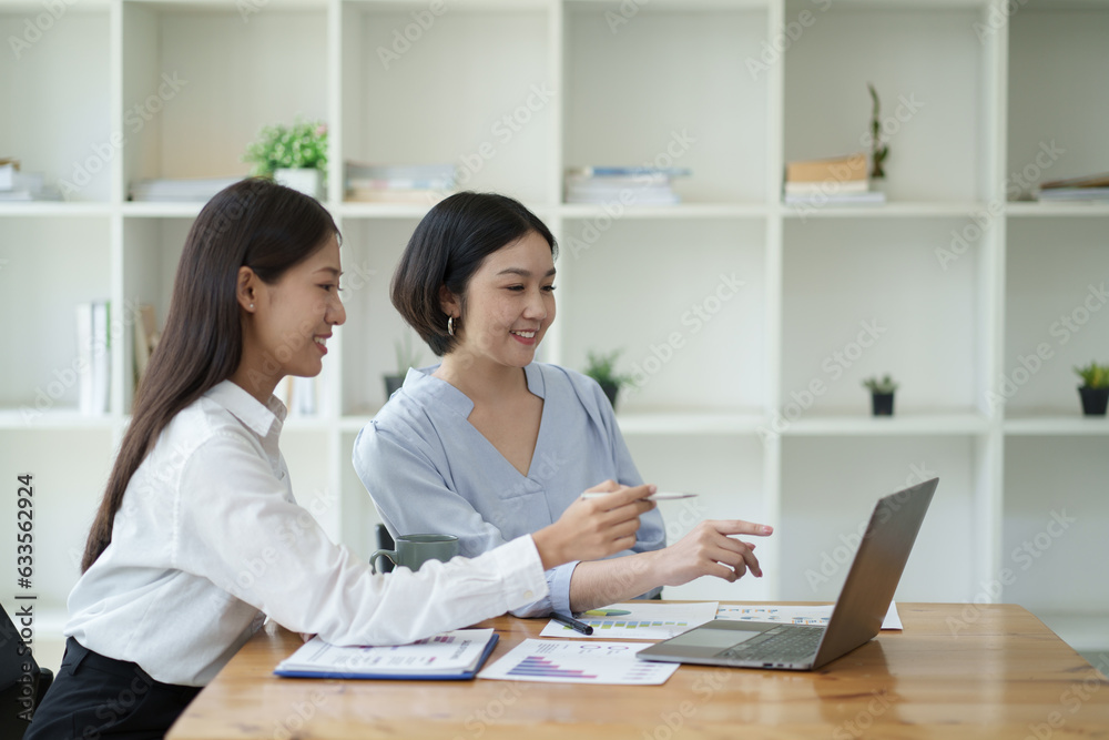 Two professional business woman working together, creating new ideas and brainstorming the concept together ing the office room. Two professional business woman working together, creating new ideas and brainstorming the concept together ing the office room.
