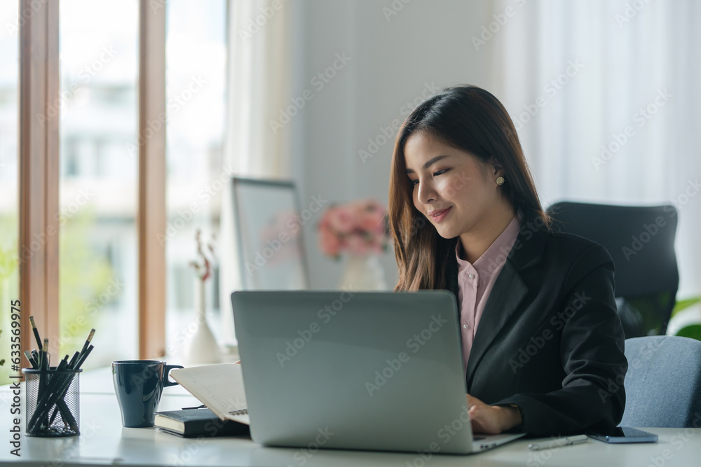 Portrait of happy young woman working on tablet pc while sitting at her working place in office. Portrait of happy young woman working on tablet pc while sitting at her working place in office.