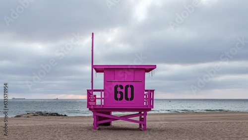 Pink Lifeguard Tower With Number 60 On The Back In The Beach. - timelapse. Breast cancer awareness. photo