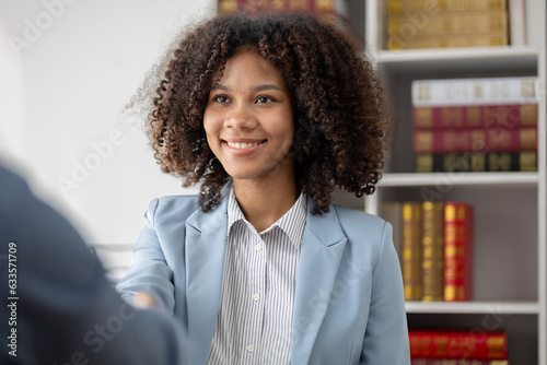 American women are litigation attorneys, female attorneys work in law firms drafting contracts and talking with clients to defend their cases. Lawyer and justice concept.