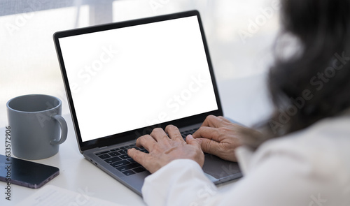 Close up view businesswoman hands typing on keyboard of laptop computer.