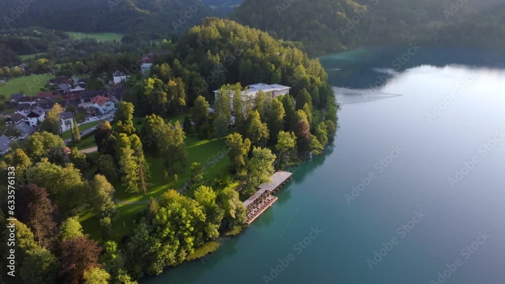 Drone video from Bled Slovenia. A beautifull glaciar lake with a beautifull island in the middle of the lake with sourouding mountains and nature. Filmed at sunset at golden hour. Drone video from Bled Slovenia. A beautifull glaciar lake with a beautifull island in the middle of the lake with sourouding mountains and nature. Filmed at sunset at golden hour.